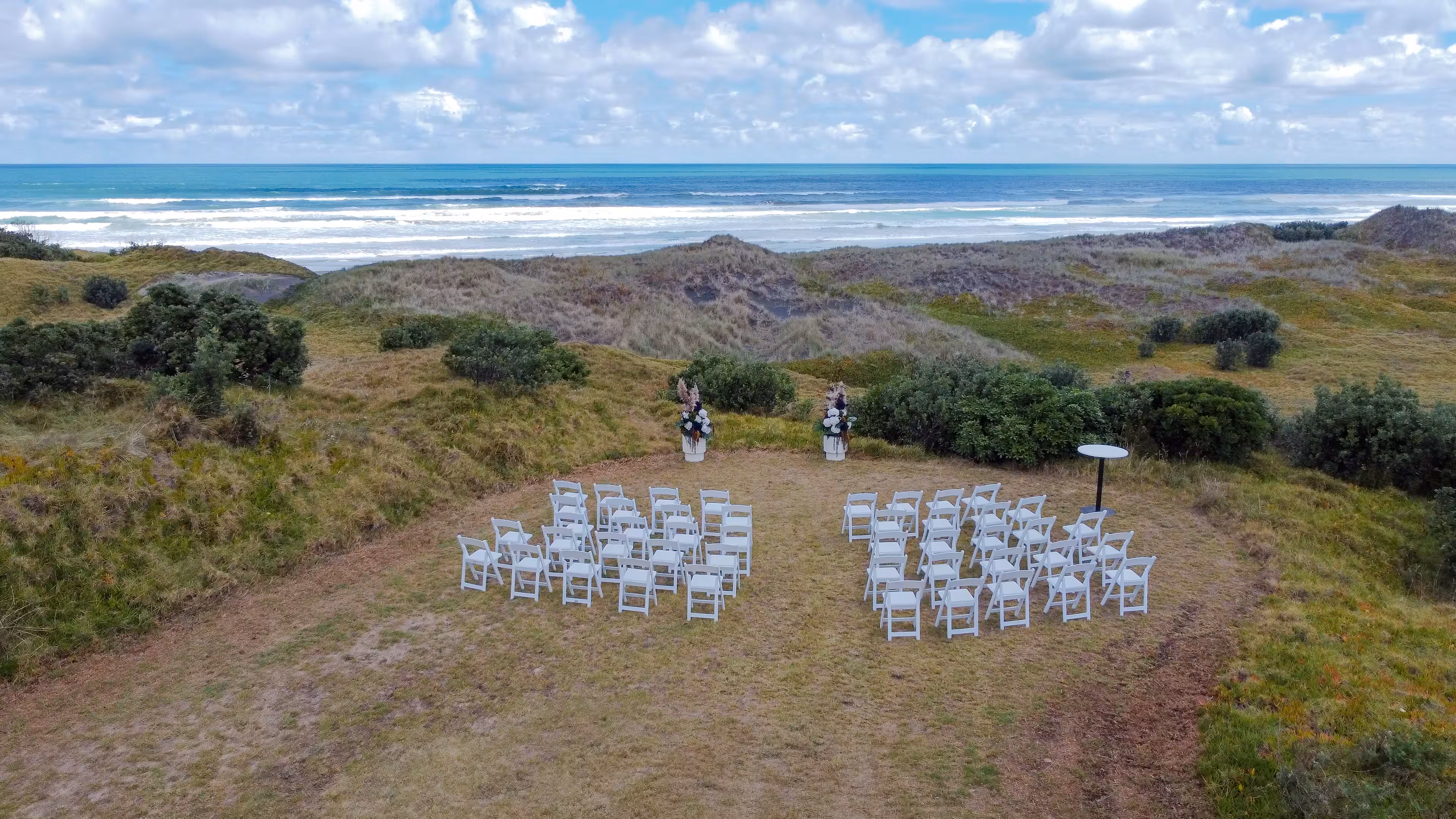 Aerial view of wedding ceremony at Muriwai Golf club on the west coast of Auckland.