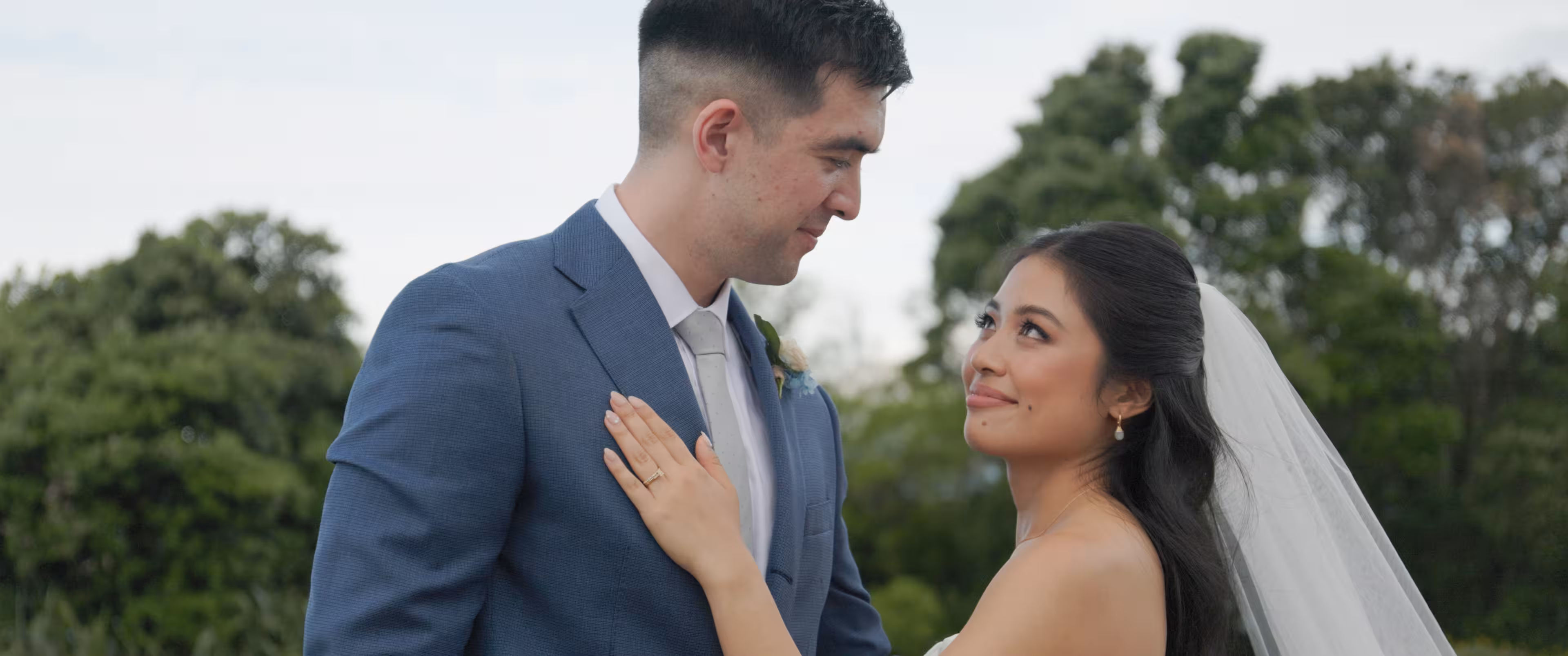 Jennifer and Terence overlooking the Auckland coastline during their bridal portraits.