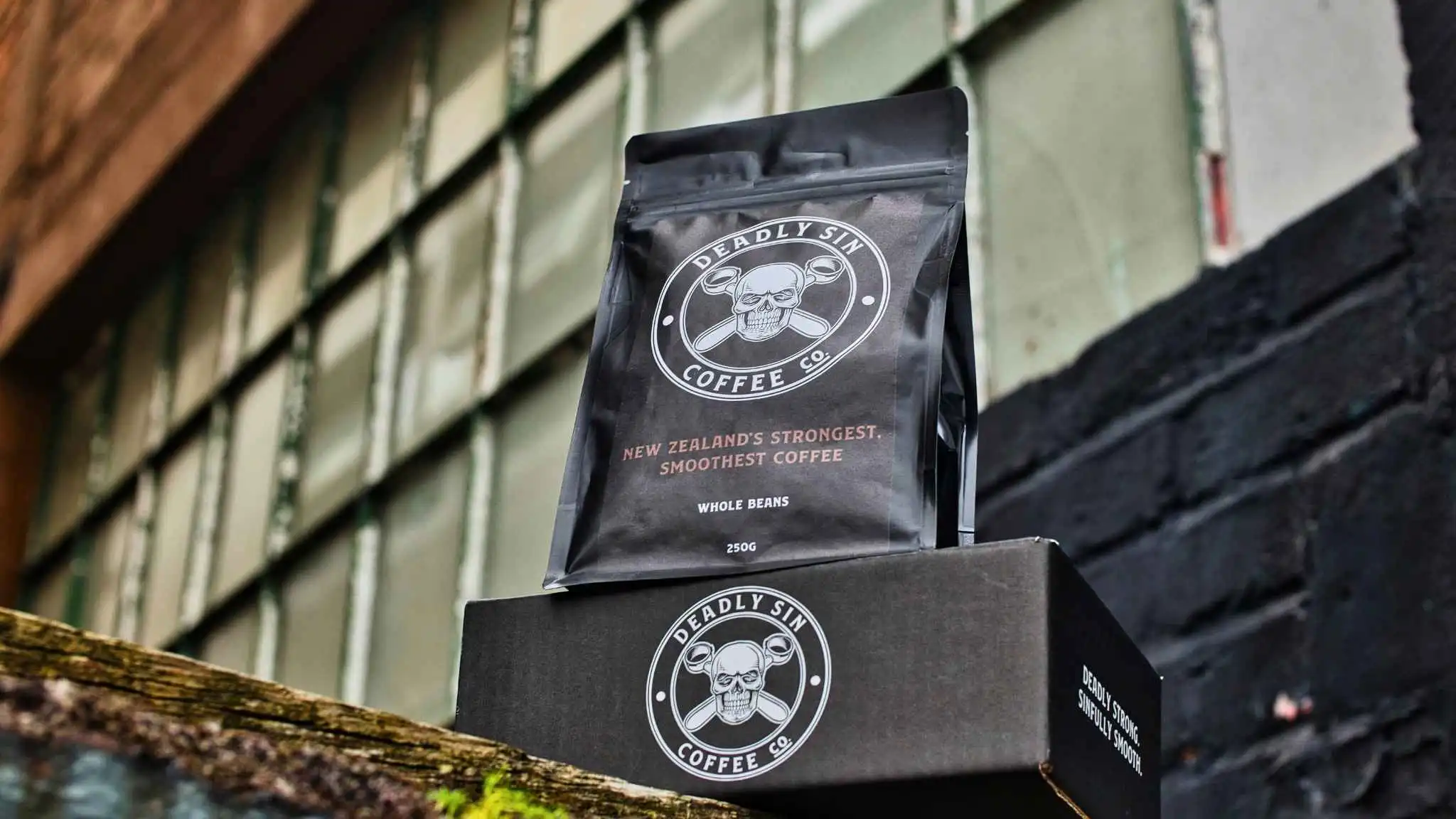 Deadly Sin Coffee Co. product shot - urban textured wall.