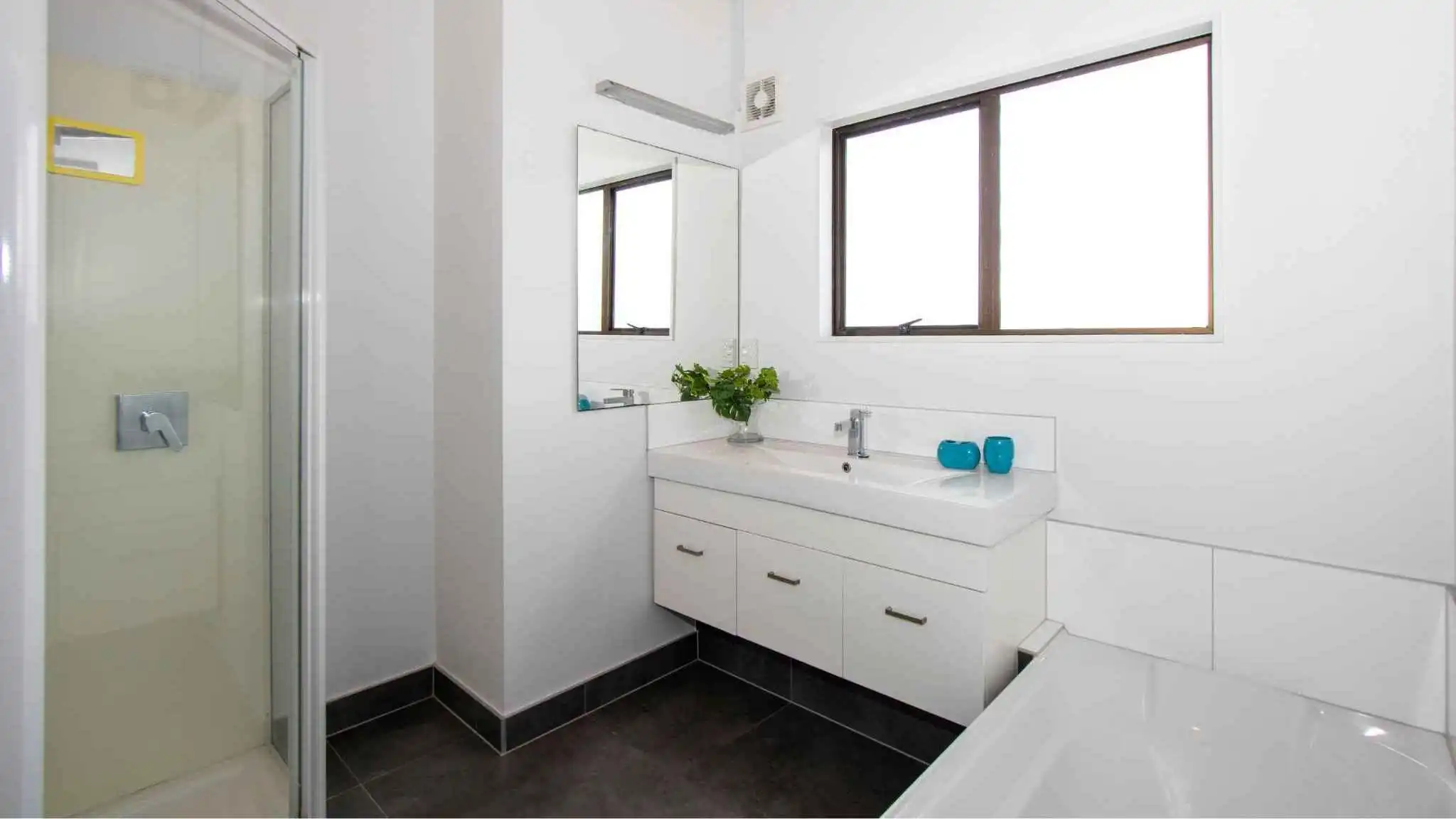 Bright modern bathroom interior with walk-in shower.