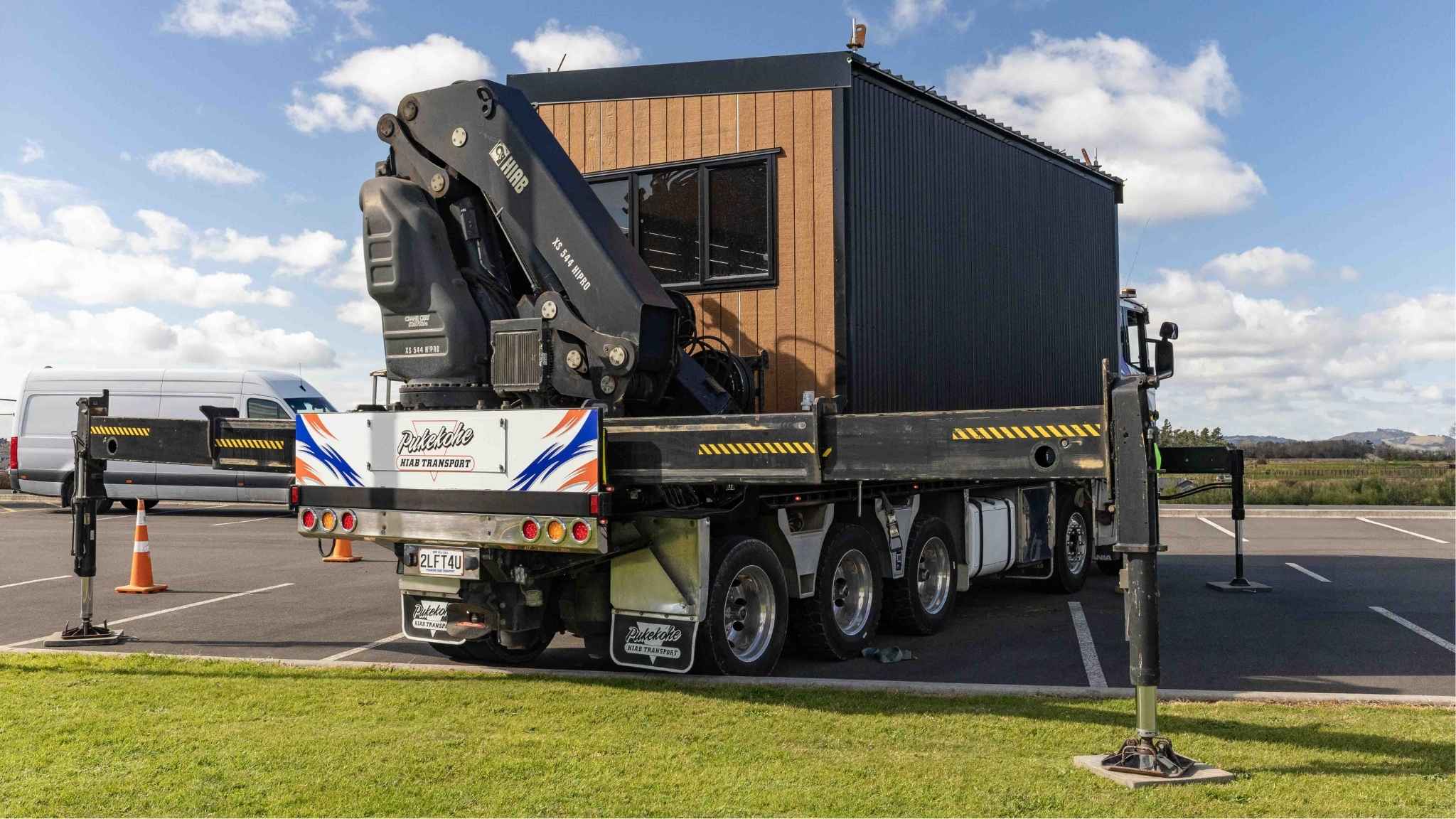 Crane truck unloading a prefabricated modular building for commercial installation project at Paerata School in Auckland, New Zealand