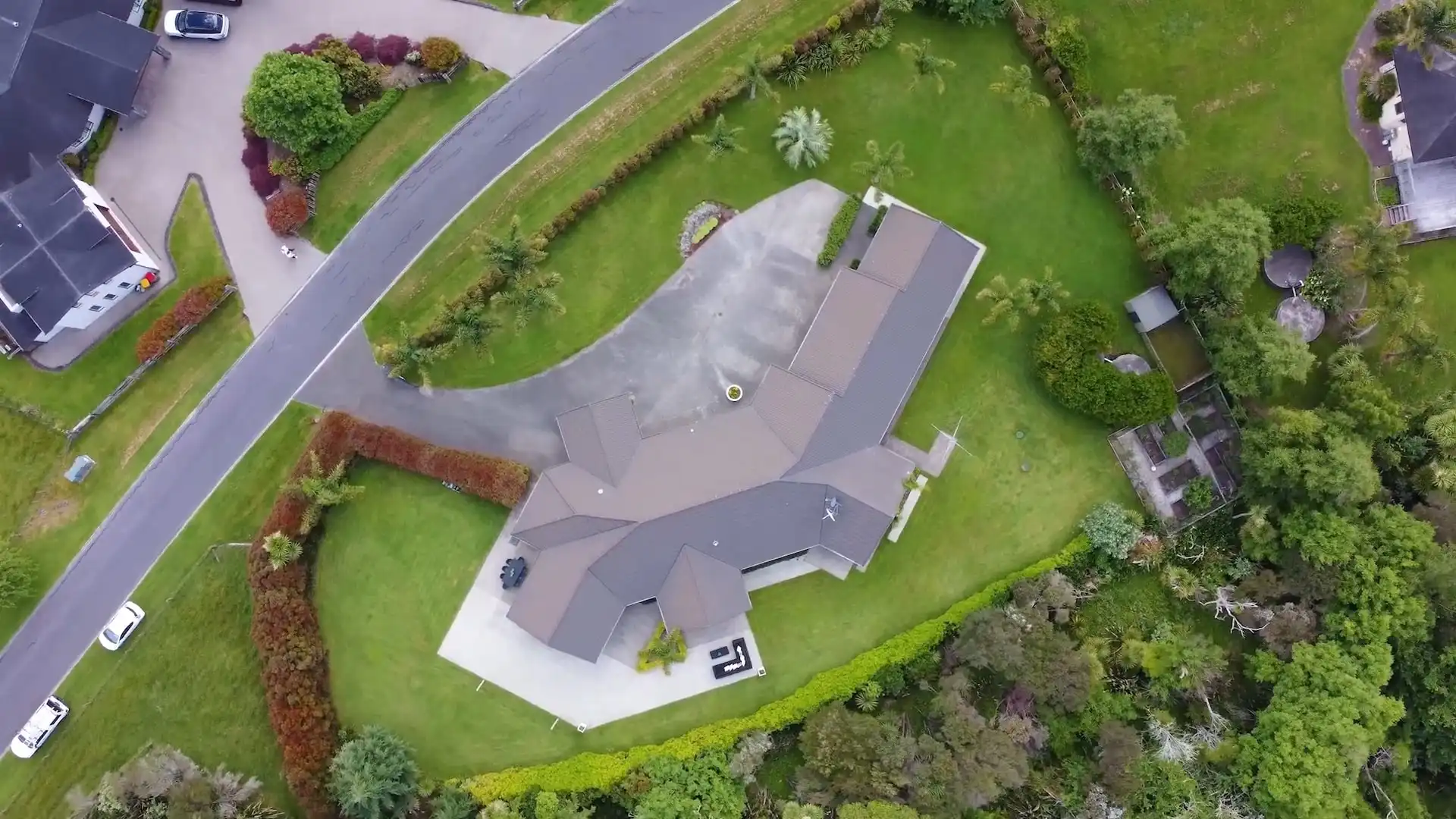 Aerial drone footage of suburban home filmed by Auckland real estate videographer.