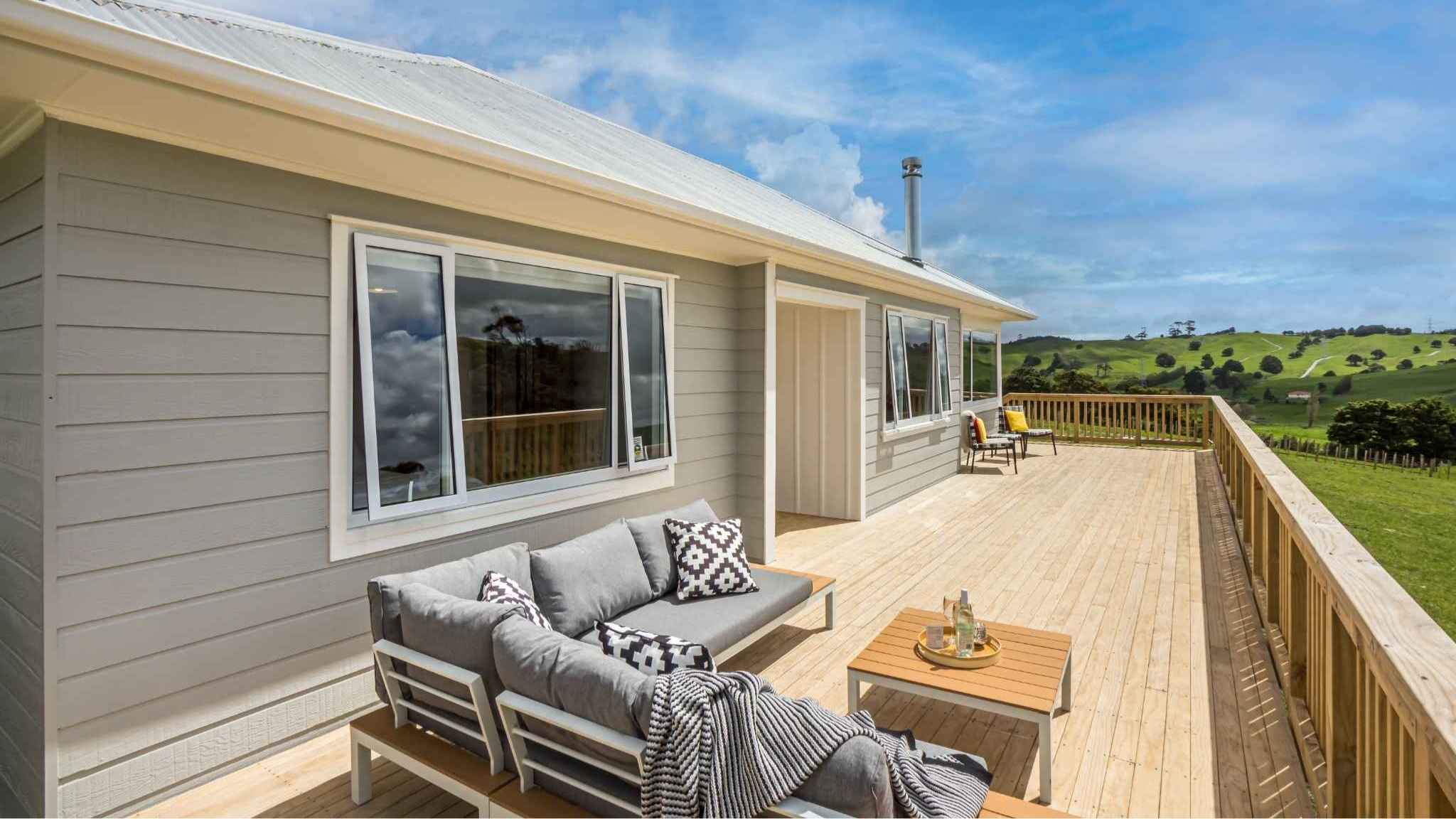 Spacious outdoor deck with seating, countryside views, and direct access from living area.